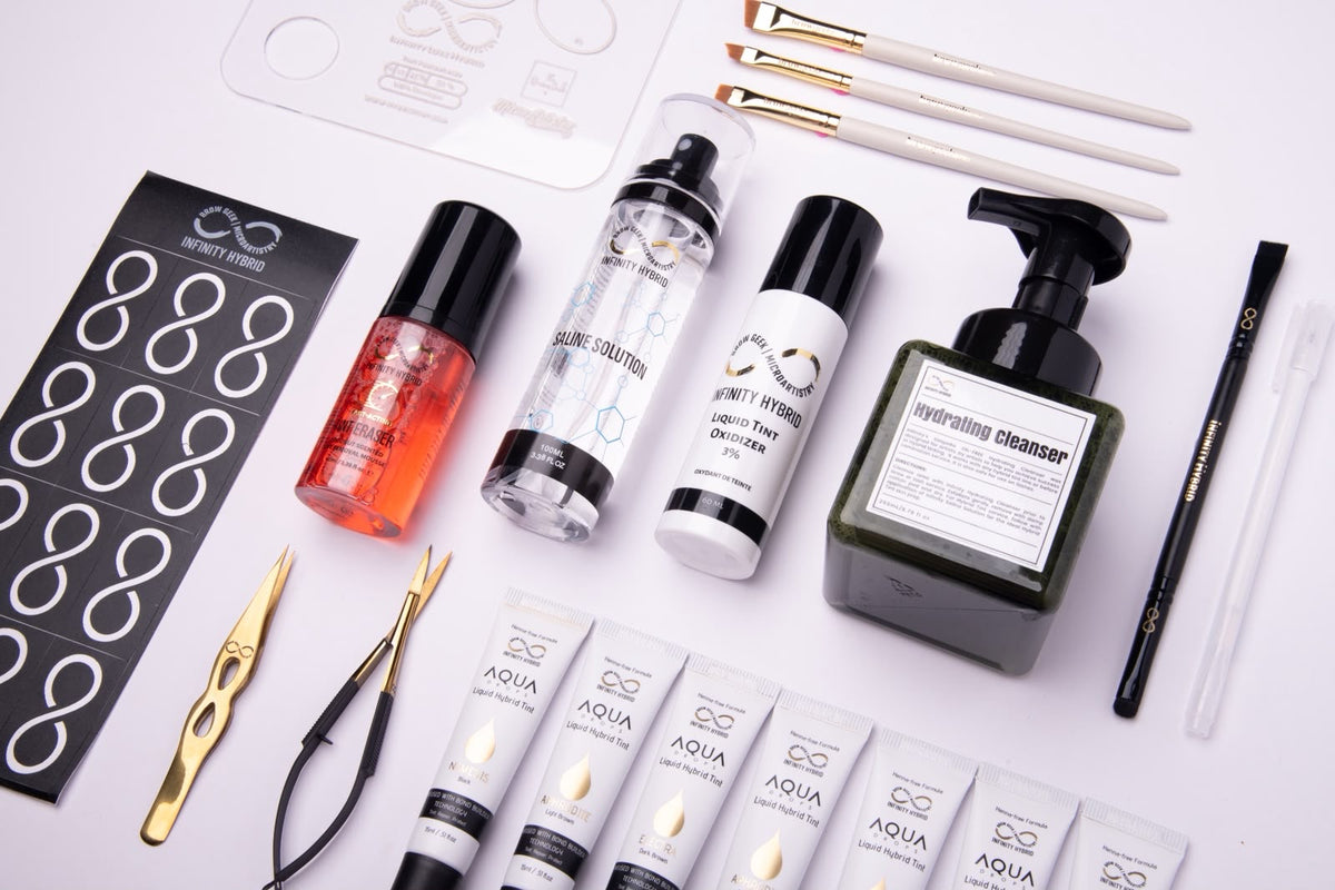 Infinity x The Brow Geek Hero Bundle contents: Aqua Drops® hybrid brow dye boxes, developer, brow cleanser, saline, brow oil, tweezers, scissors and stencils
